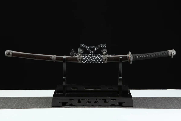 Sakura Katana samurai sword fully sheathed in lacquered saya with leather frame.